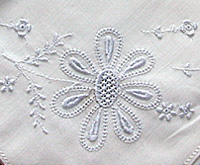 Detail of hand embroidered handkerchief in whitework techniques