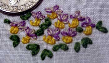 Separated strands of floche in hand embroidered flowers