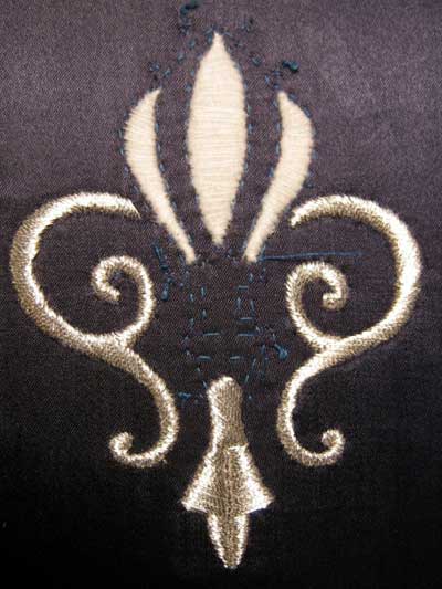Satin Stitching with Metal Threads: Fleur-de-lis in silver thread on blue silk ground