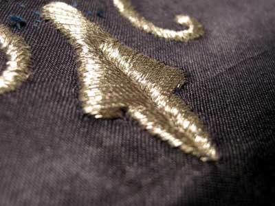 Satin Stitching with Metal Threads: Fleur-de-lis in silver thread on blue silk ground