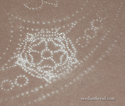 Sanding the back of an embroidery pattern