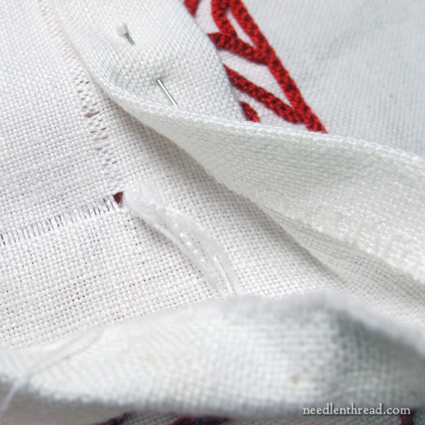Hem stitching on an embroidered redwork table runner