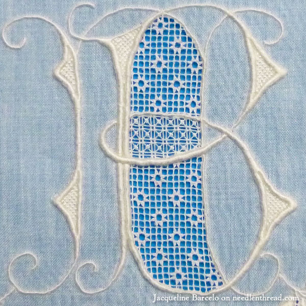 Fine whitework embroidery, monogram, and needle lace on muslin
