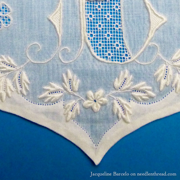 Fine whitework embroidery, monogram, and needle lace on muslin