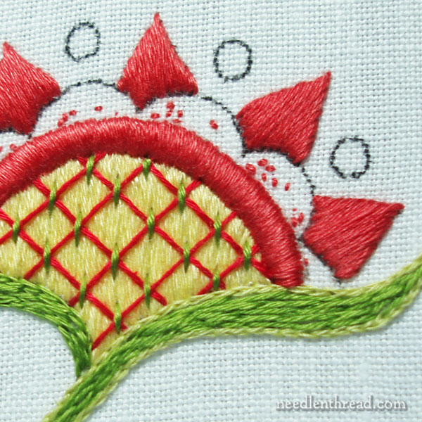 Embroidery with satin stitch and floche