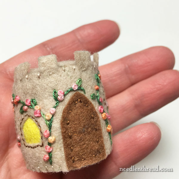 Bottle cap pincushion with embroidered felt