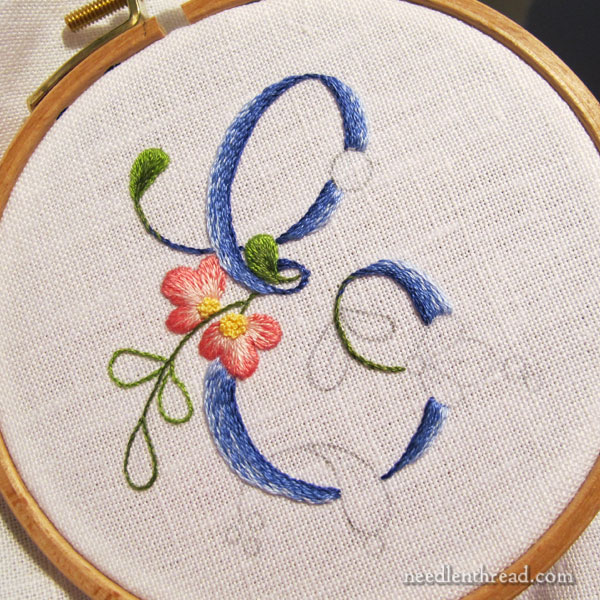 E Monogram embroidered in shaded stem stitch filling