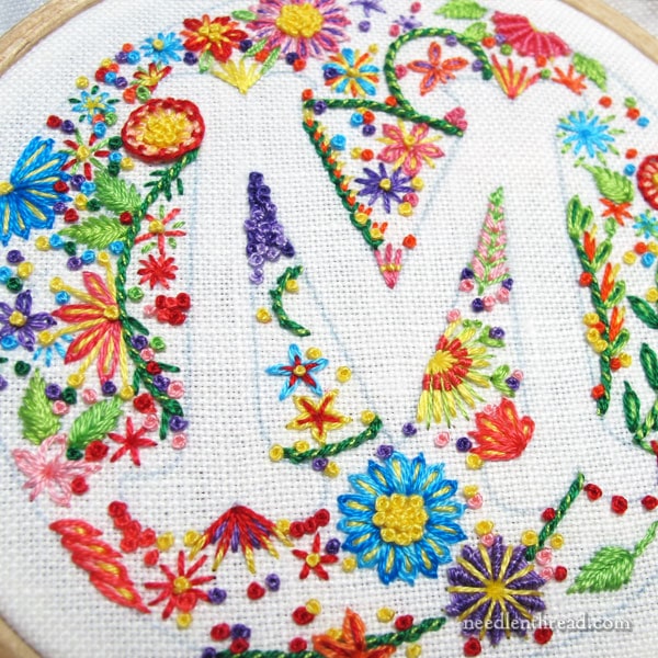 voided monogram m in embroidery