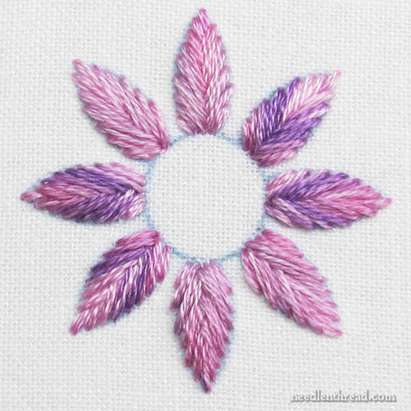 Flower stitched with variegated floss, with one strand reversed