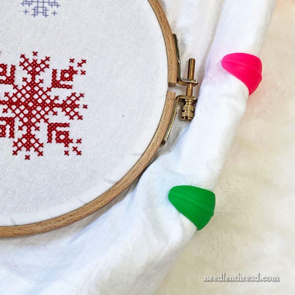 Spool Huggers for controlling excess fabric on embroidery hoops