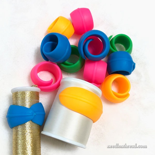 Spool Huggers for controlling excess fabric on embroidery hoops